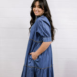 Woman wearing a blue dress against a white background