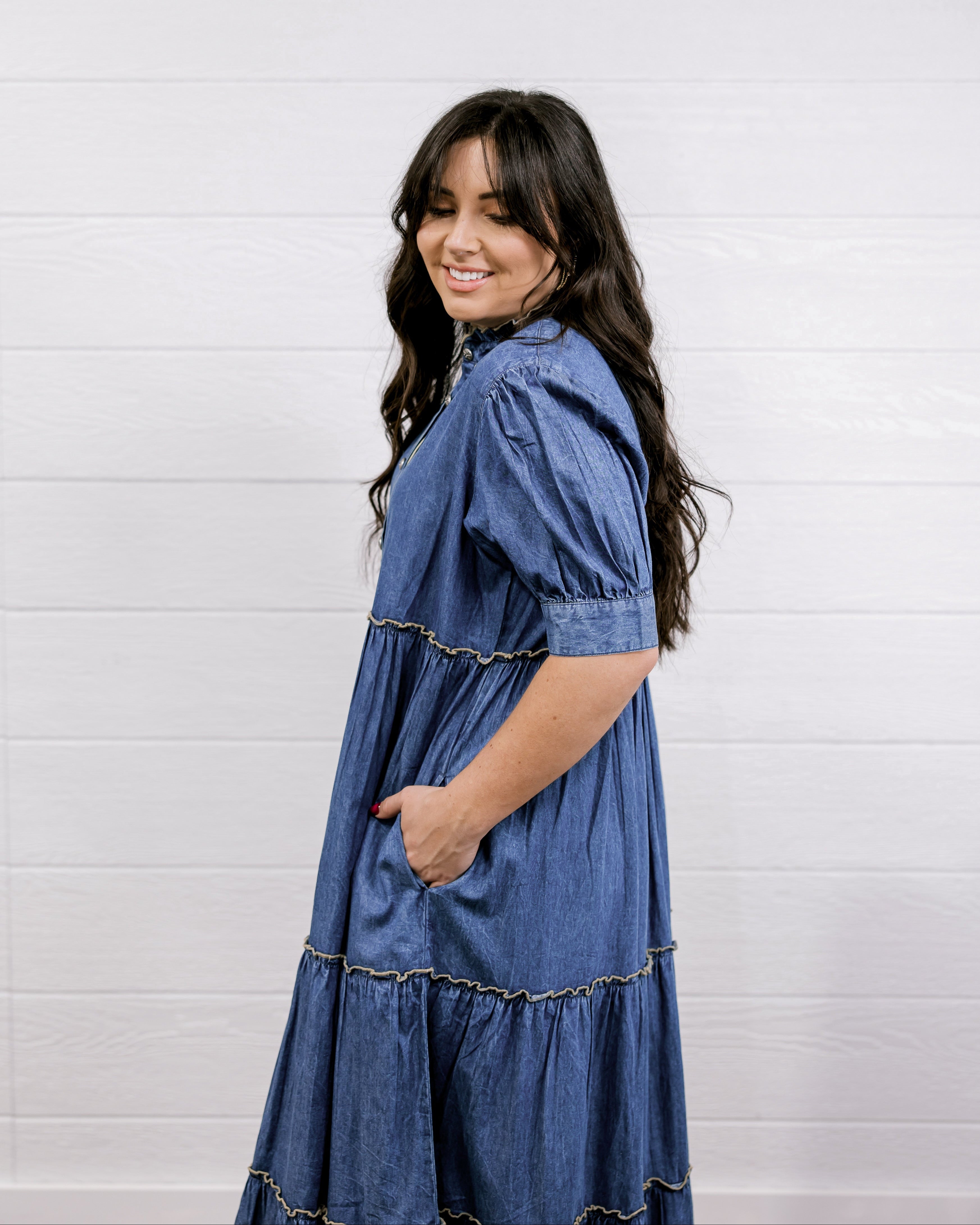 Woman wearing a blue dress against a white background