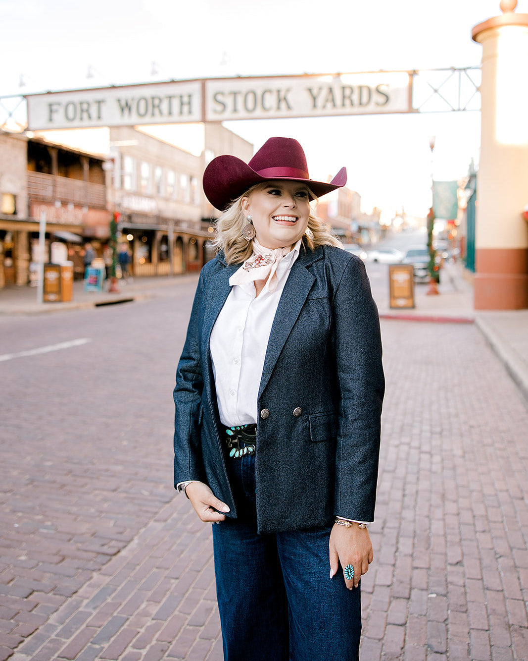 Women wearing a denim blazer on the city streets. 