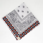 Zoomed out image of the burnt orange floral frilly. Floral pattern is embroidered. 