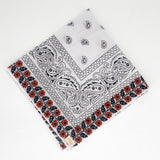 Zoomed out image of the burnt orange floral frilly. Floral pattern is embroidered. 