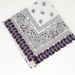 Zoomed out image of purple floral frilly. Floral print is embroidered. 