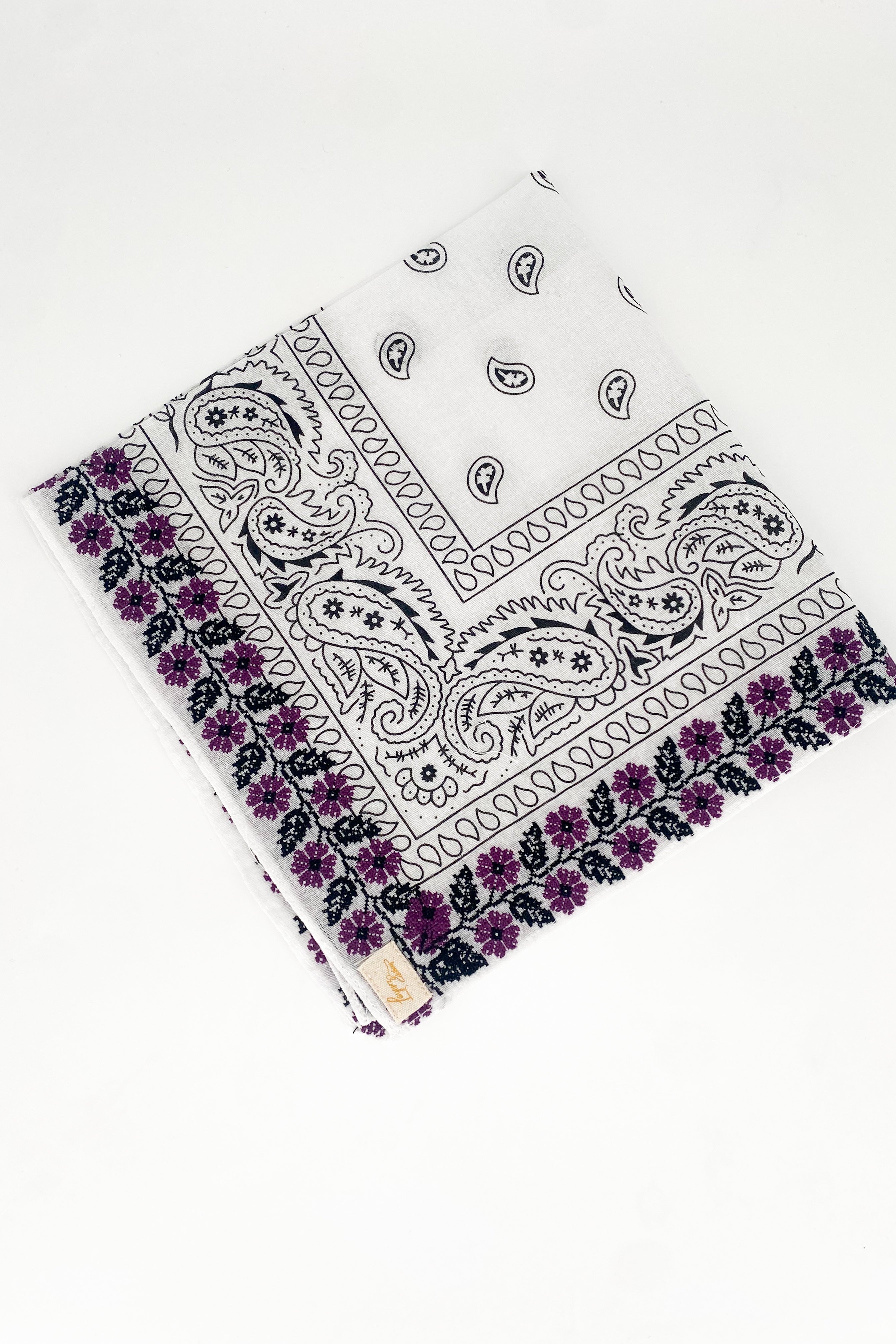 Zoomed out image of purple floral frilly. Floral print is embroidered. 