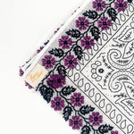 Zoomed in version of purple floral frilly. Emphasis on embroidered floral print. 