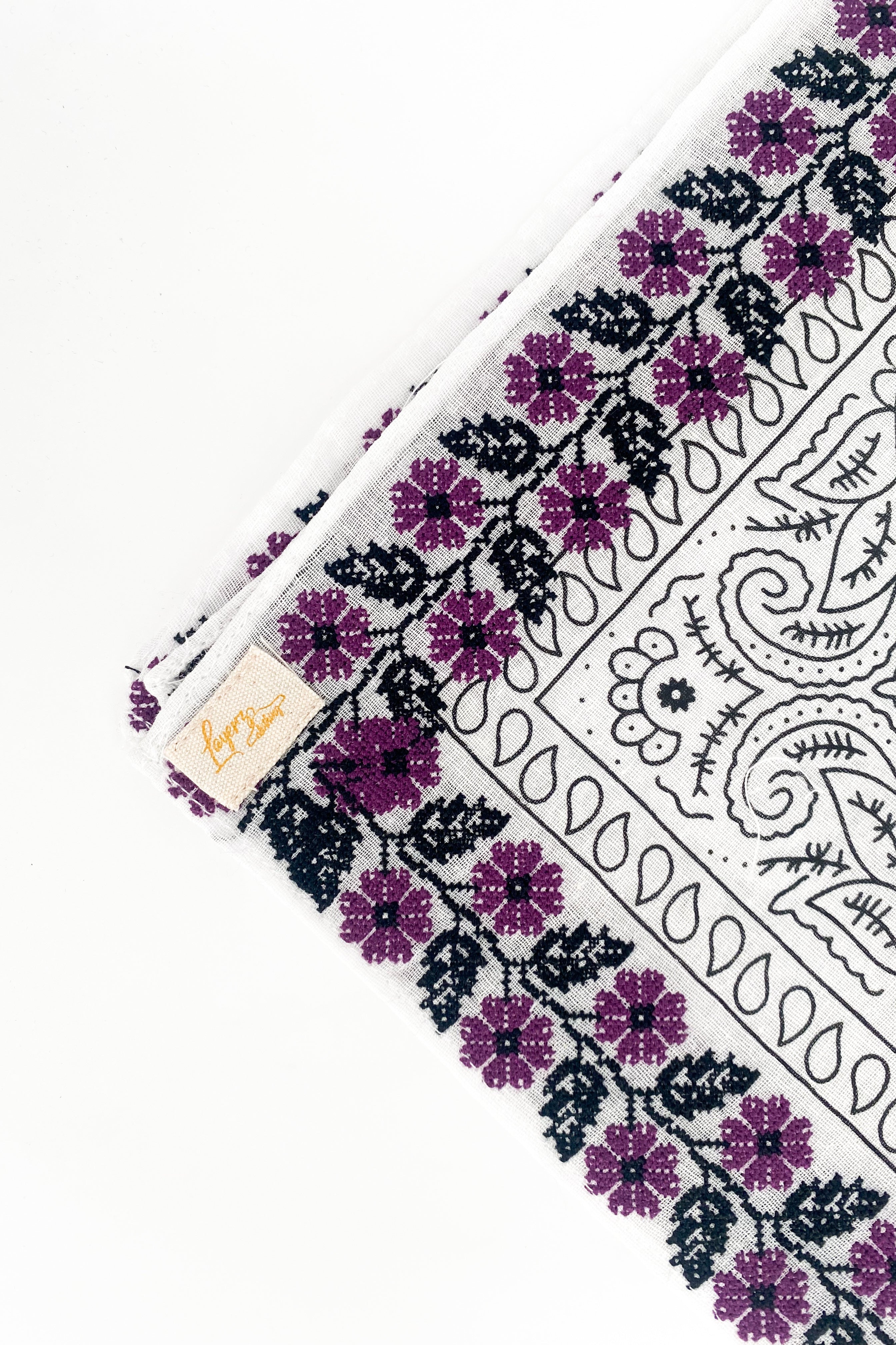 Zoomed in version of purple floral frilly. Emphasis on embroidered floral print. 