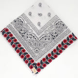 Zoomed out image of red floral frilly. Floral is embroidered. 