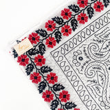 Zoomed in version of floral red frilly. Emphasis on the red floral embroidery. 