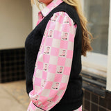 Woman with blonde hair wearing a button-down long-sleeve with black and pink boots graphics on a pink & white checkered background. the model paired this top with dark-wash denim jeans. 