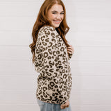 Woman wearing a leopard print sweater against a white background