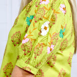 Woman in blonde hair showing in depth perception of sleeve details at a side angle in the Margo Top. The background of picture is white. 