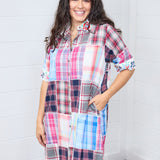Woman with dark hair standing in a front profile position wearing the Paisley Tunic against a white background. The focal point in this image is the front of the dress, buttons down the front, embroidered floral collar, and embroidered floral cuffs. 