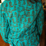 Woman with dark hair wearing the Sadie Body style with brown boots graphics along top and bow. Model paired this top with light-wash denim jeans. 