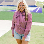 Woman with blonde hair wearing maroon gingham long-sleeve, tied in the front with light-wash denim shorts. 