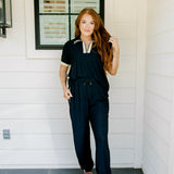 Woman with red hair wearing navy and gold shimmer pants. Model paired this top with Sparkle Top-Navy.