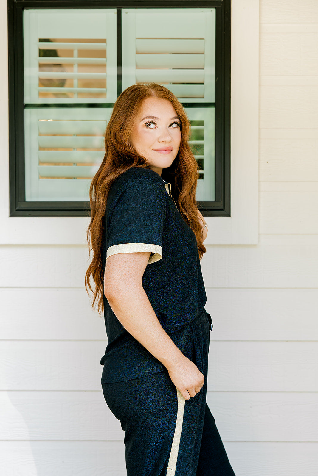 Woman with red hair wearing navy and gold shimmer pants. Model paired this top with Sparkle Top-Navy.
