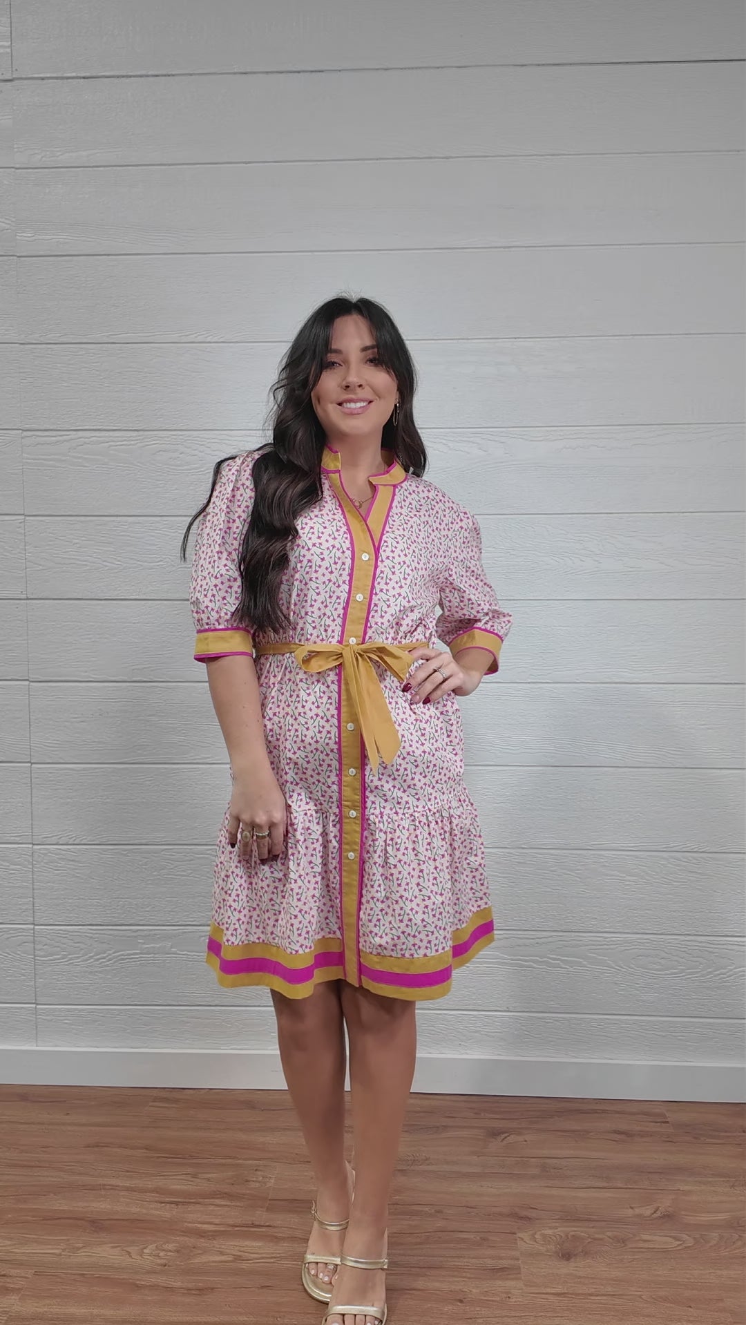Women wearing pink and yellow floral dress twirling 