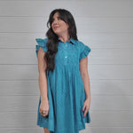 Women wearing a blue dress twirling. 