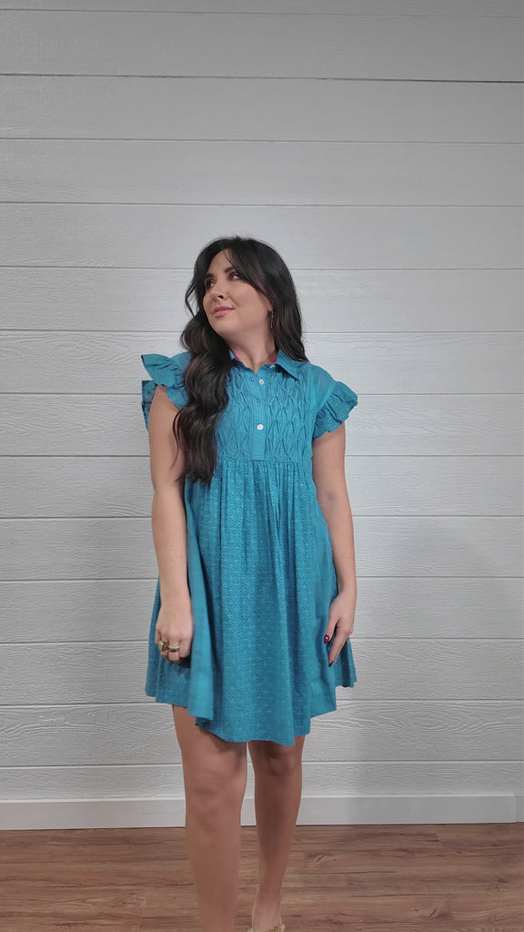 Women wearing a blue dress twirling. 
