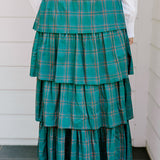 Woman wearing a green/red plaid maxi ruffle skirt with the Renee Top-White. 